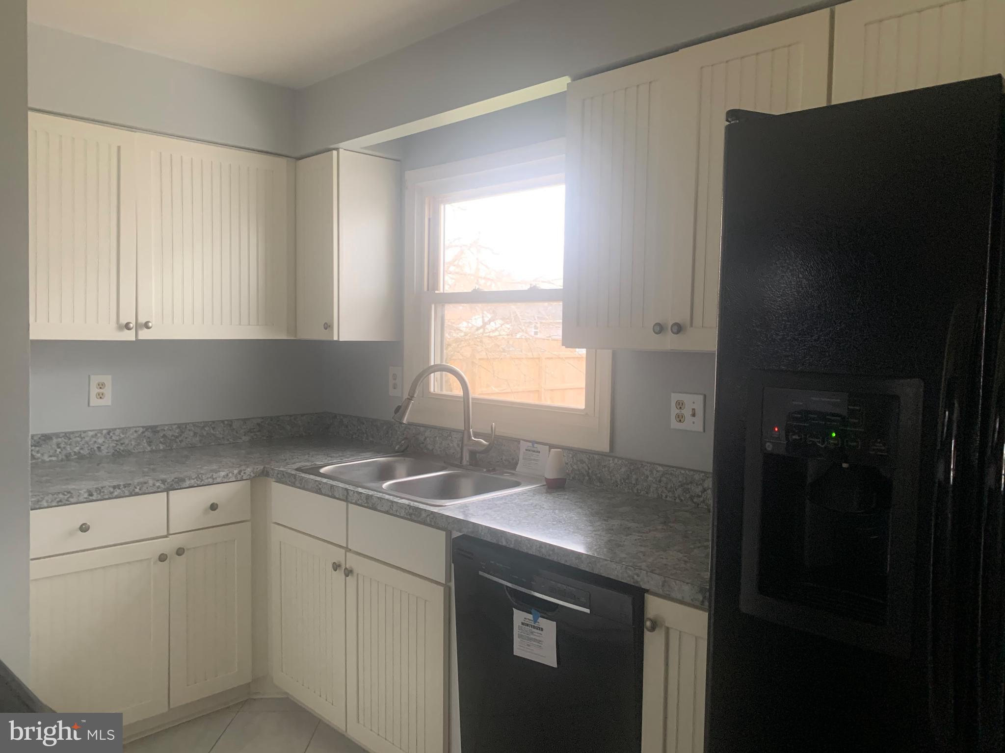 5866 Deale Churchton Road Deale, MD 20751 - Photo 16 of 26 a kitchen with a sink stove and refrigerator