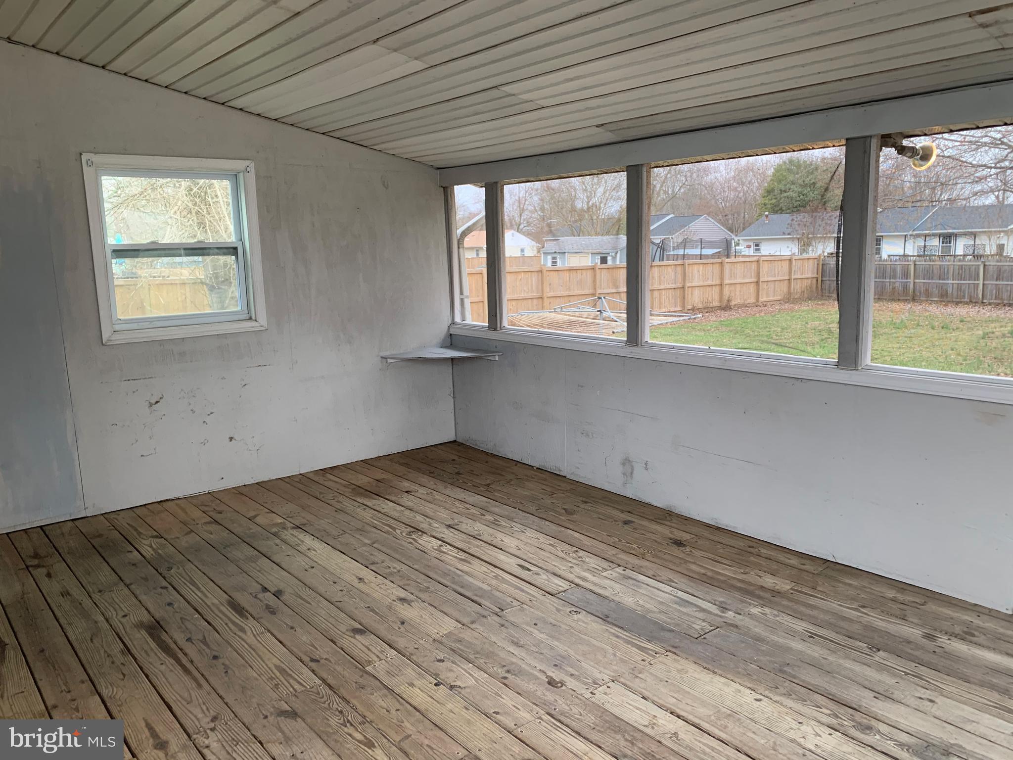 5866 Deale Churchton Road Deale, MD 20751 - Photo 18 of 26 a view of empty room with wooden floor and fan