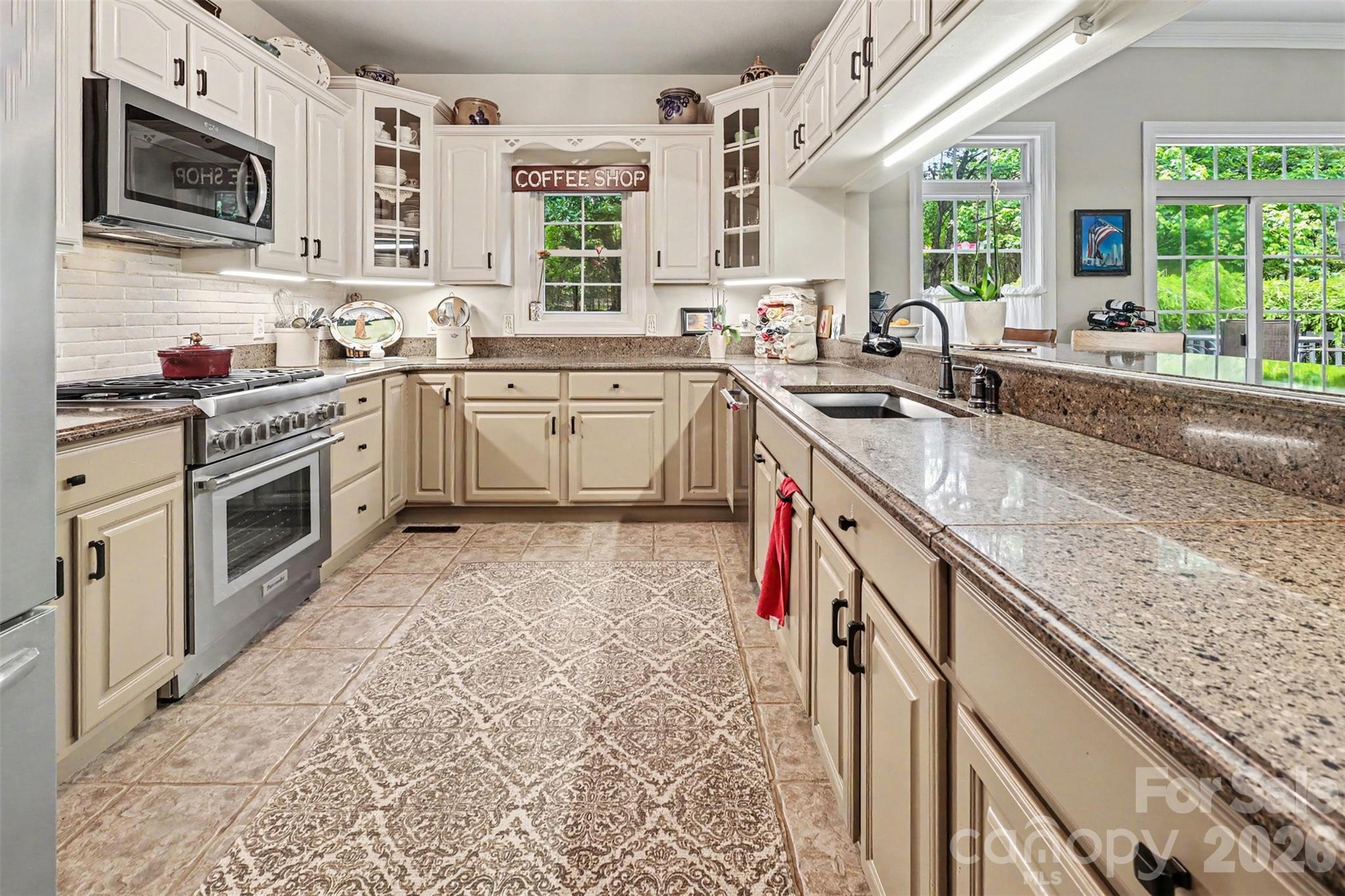 4037 Old Williamston Road Belton, SC 29627 - Photo 11 of 41 a kitchen with stainless steel appliances granite countertop a sink stove and oven