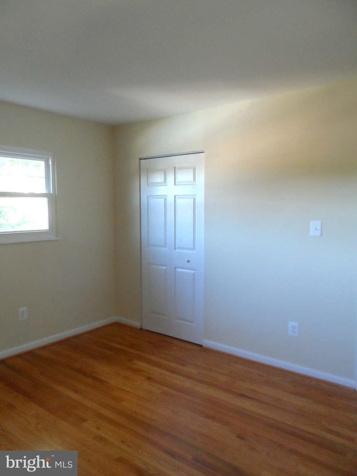 5704 Westgate Road Lanham, MD 20706 - Photo 12 of 25 a view of an empty room with wooden floor and a window