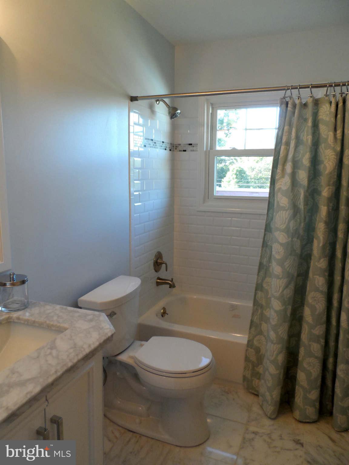 5704 Westgate Road Lanham, MD 20706 - Photo 16 of 25 a bathroom with a granite countertop sink toilet and shower
