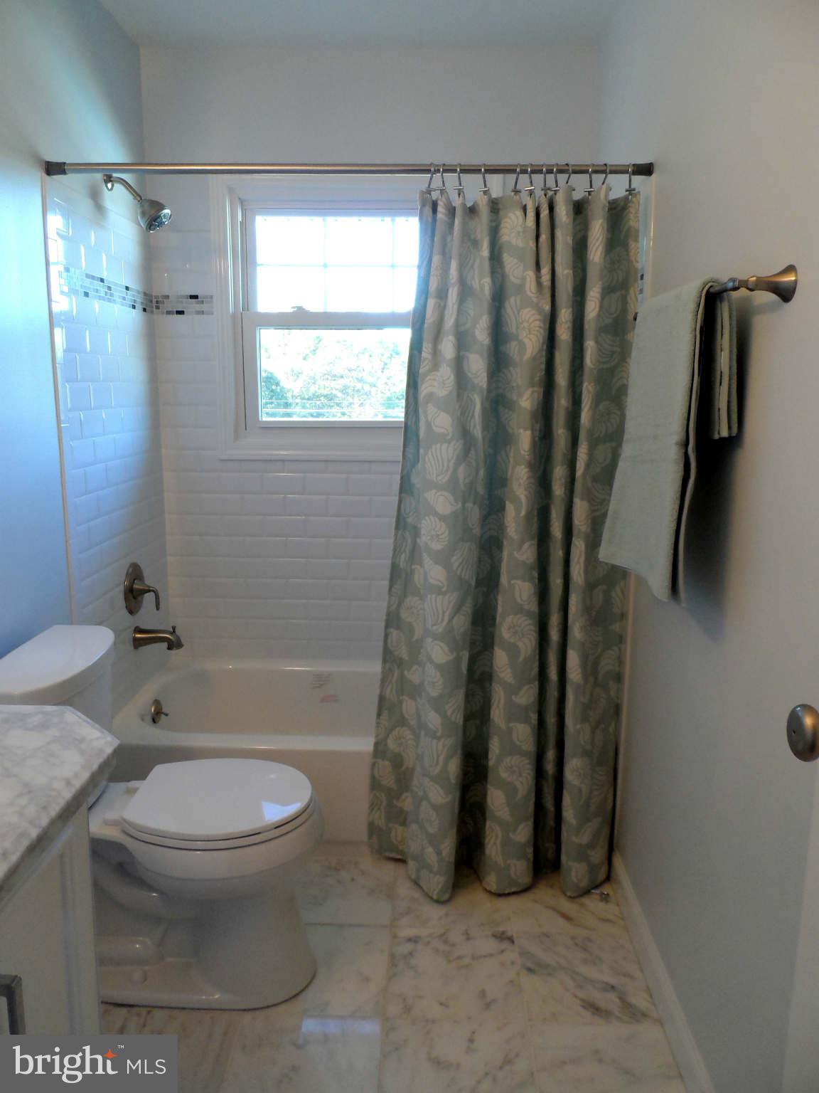 5704 Westgate Road Lanham, MD 20706 - Photo 17 of 25 a bathroom with a toilet and a shower