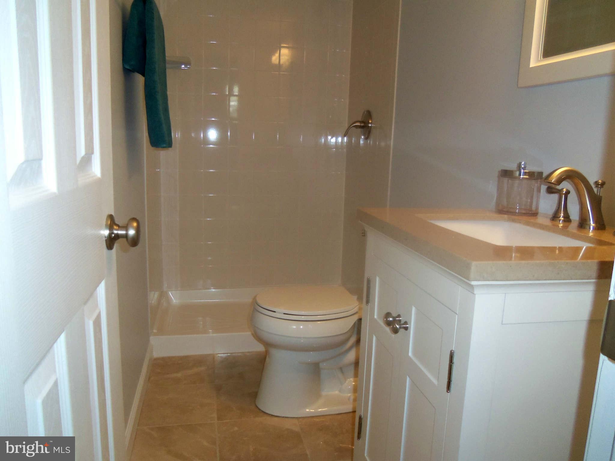 5704 Westgate Road Lanham, MD 20706 - Photo 20 of 25 a bathroom with a sink toilet and shower