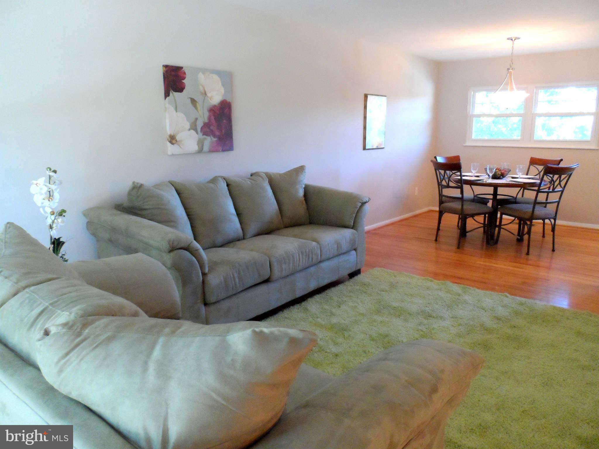 5704 Westgate Road Lanham, MD 20706 - Photo 6 of 25 a living room with furniture and a dining table with kitchen view