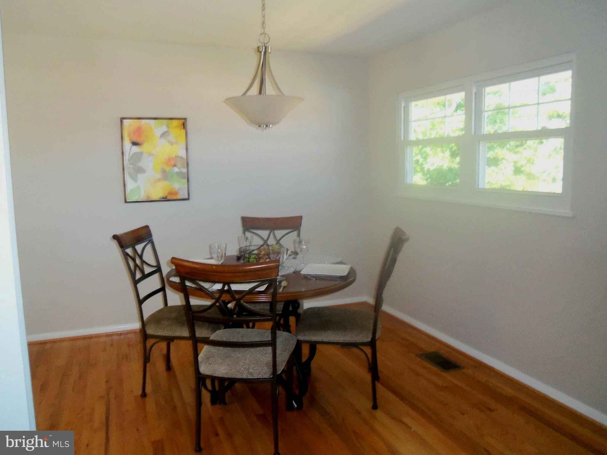 5704 Westgate Road Lanham, MD 20706 - Photo 7 of 25 a view of a dining room with furniture wooden floor and a window