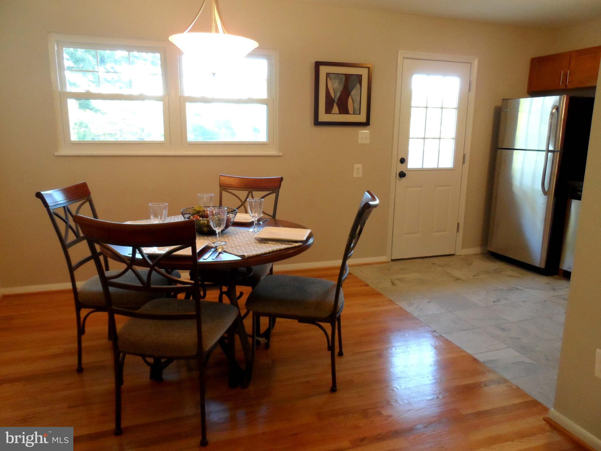5704 Westgate Road Lanham, MD 20706 - Photo 8 of 25 a view of a dining room with furniture window and wooden floor