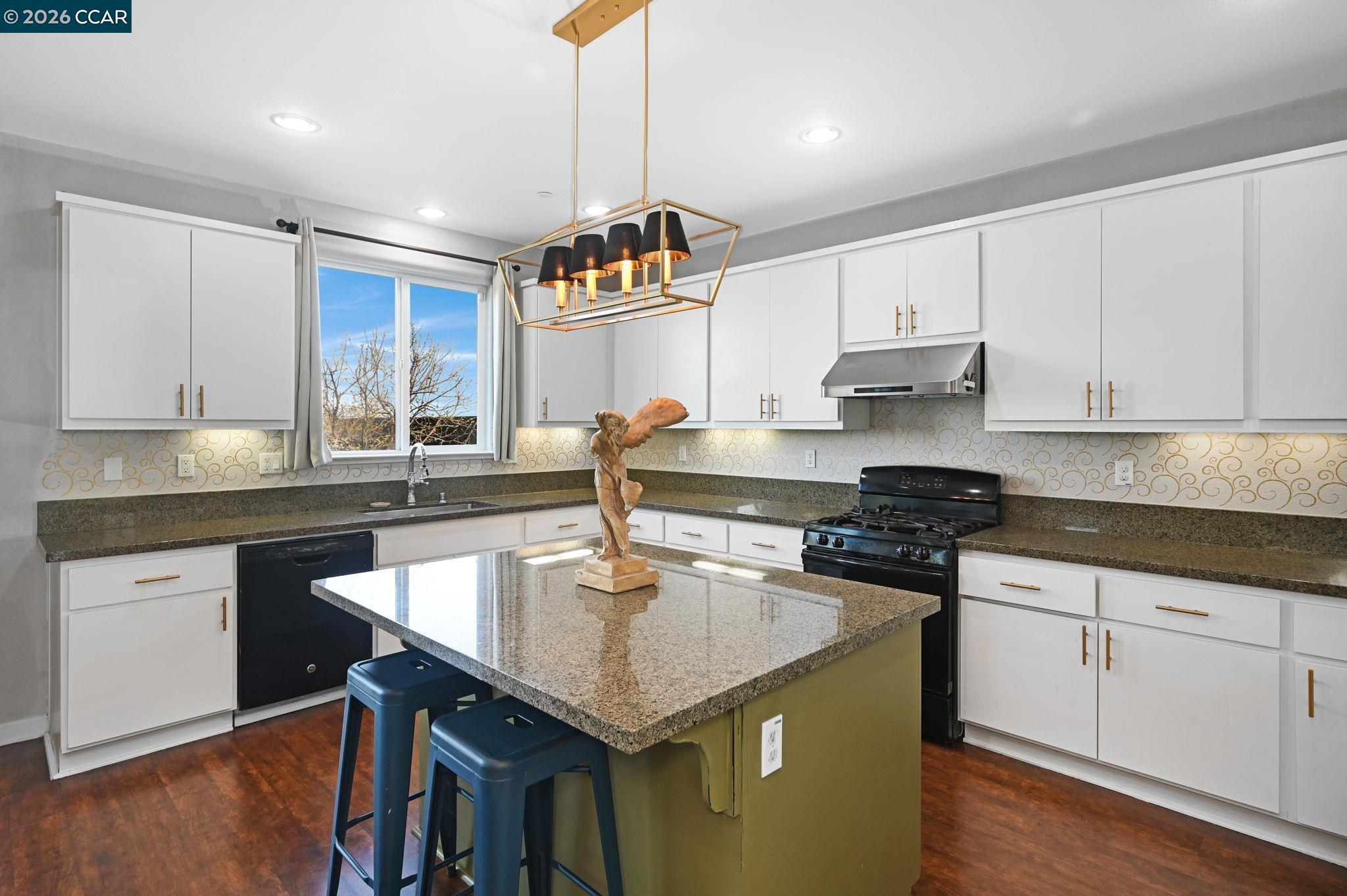 130 Savona Way Bay Point, CA 94565 - Photo 11 of 41 a kitchen with granite countertop a sink a counter space appliances and cabinets