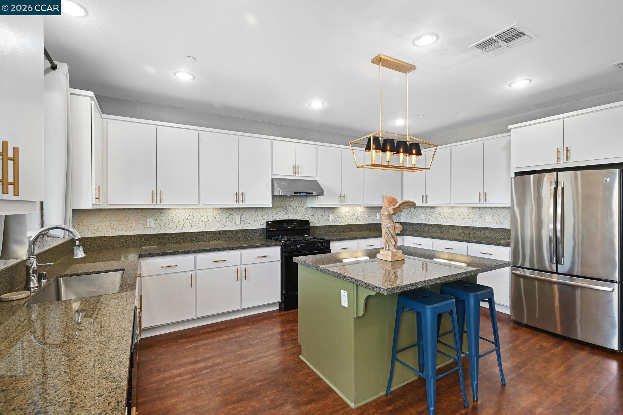130 Savona Way Bay Point, CA 94565 - Photo 13 of 41 a kitchen with kitchen island a sink stove and refrigerator