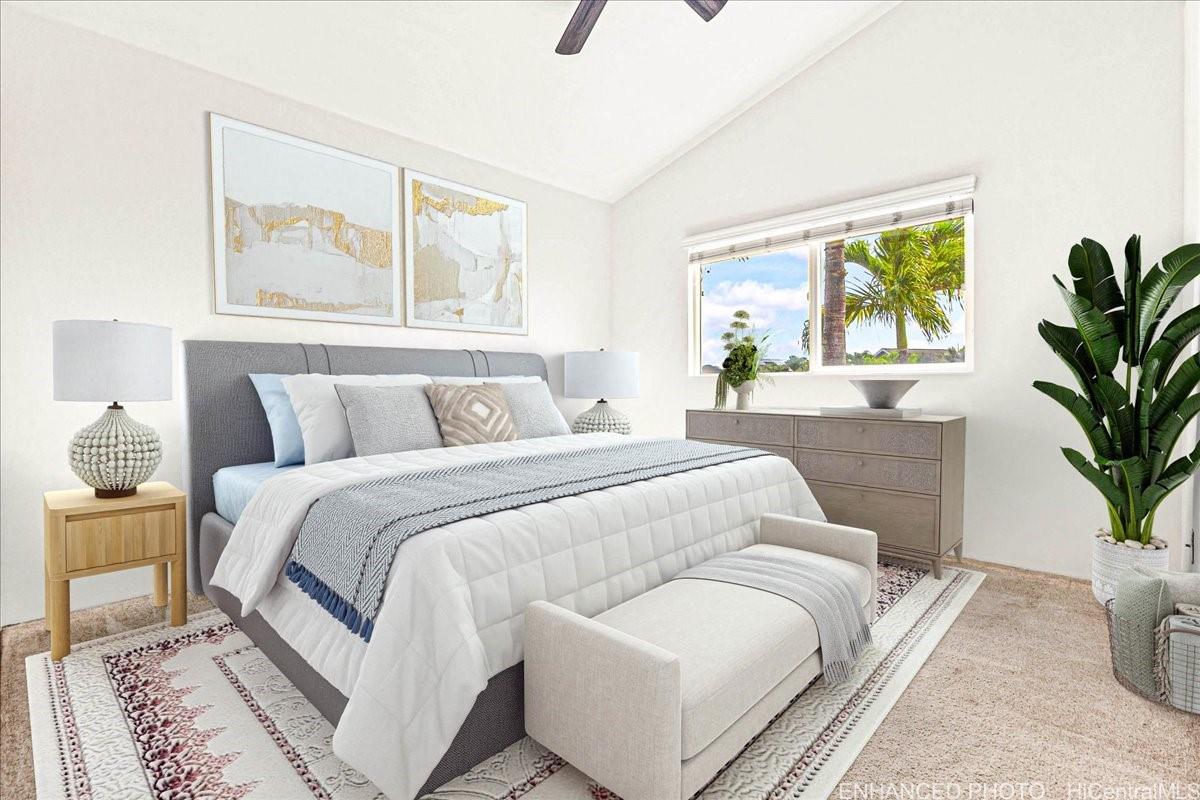 91-1121 Keoneula Boulevard, Unit L5 Ewa Beach, HI 96706 - Photo 11 of 20 a bedroom with a large bed and a potted plant