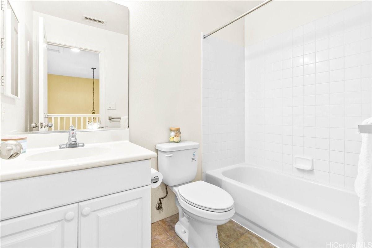 91-1121 Keoneula Boulevard, Unit L5 Ewa Beach, HI 96706 - Photo 15 of 20 a bathroom with a sink a toilet and a bathtub