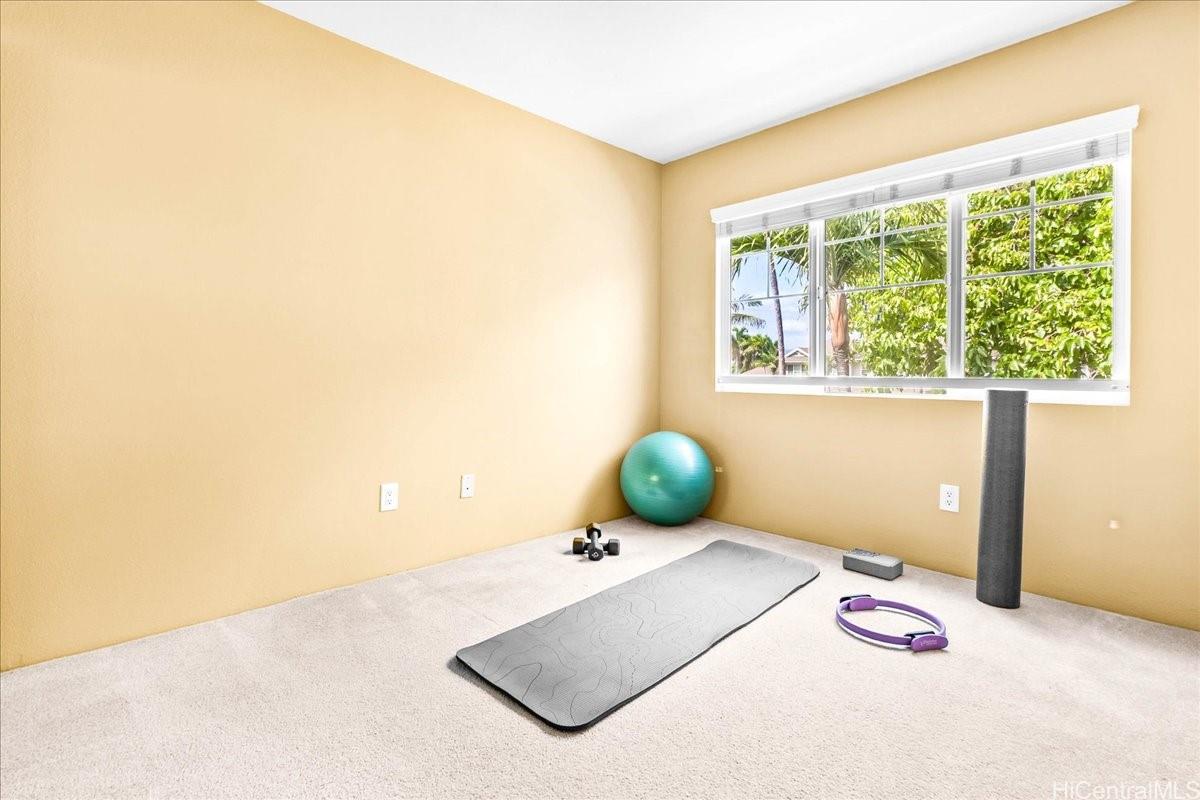 91-1121 Keoneula Boulevard, Unit L5 Ewa Beach, HI 96706 - Photo 16 of 20 a bedroom with a bed and a window