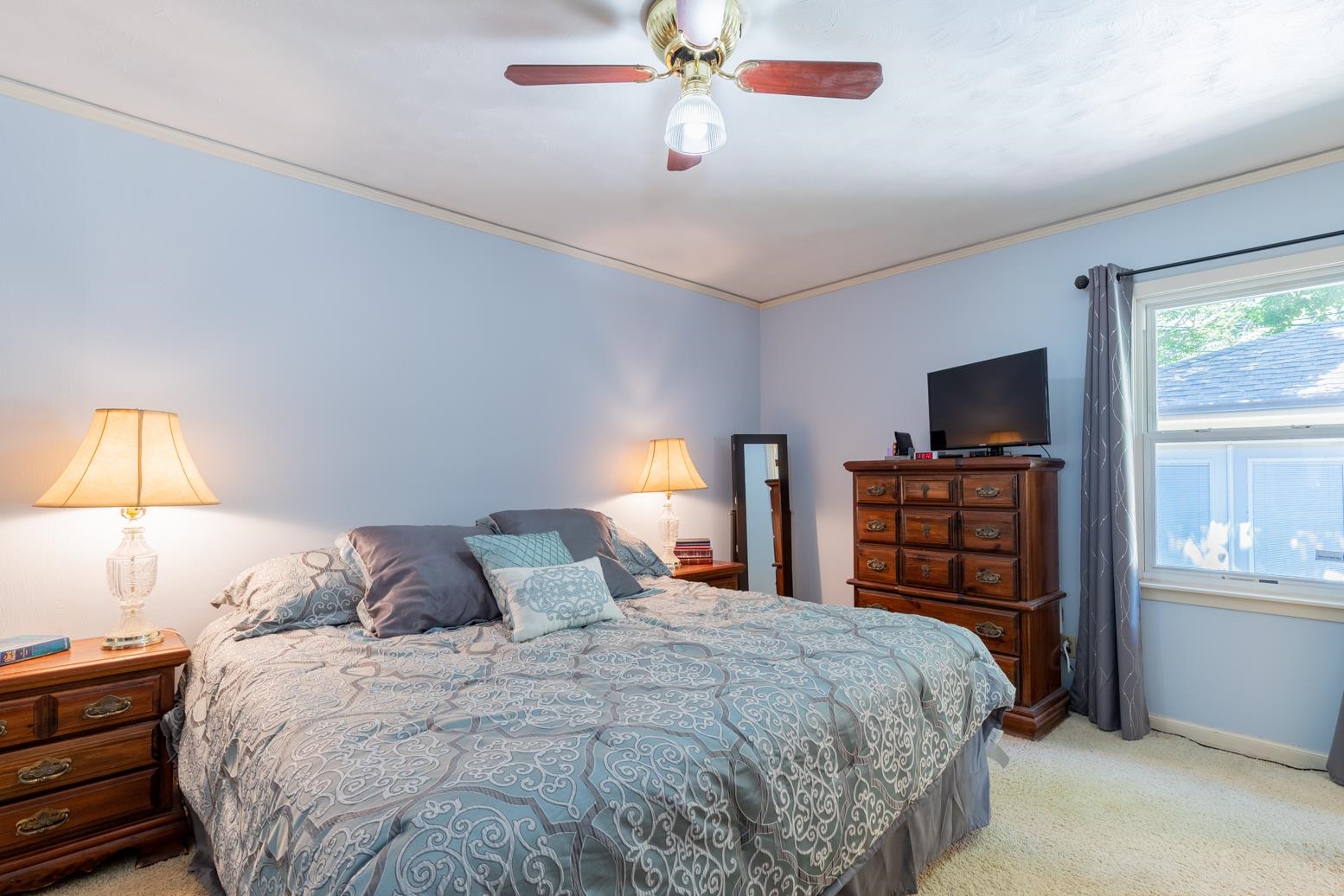 5098 Mason Road Memphis, TN 38117 - Photo 14 of 25 a bedroom with a bed a dresser and a chandelier