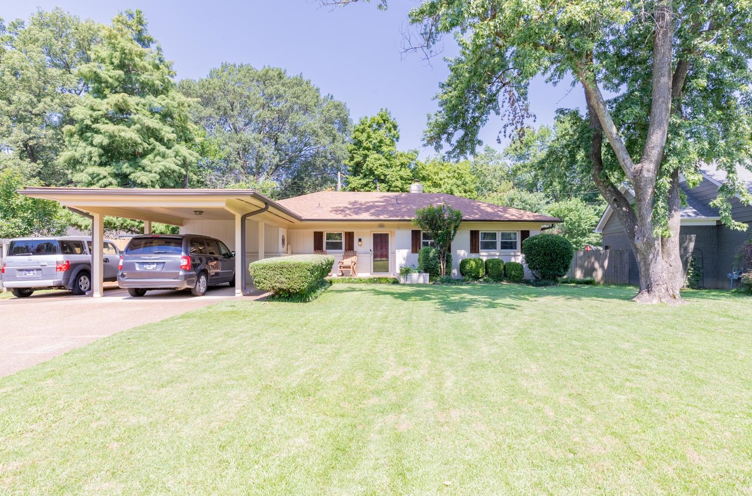 5098 Mason Road Memphis, TN 38117 - Photo 2 of 25 a front view of a house with a garden and trees