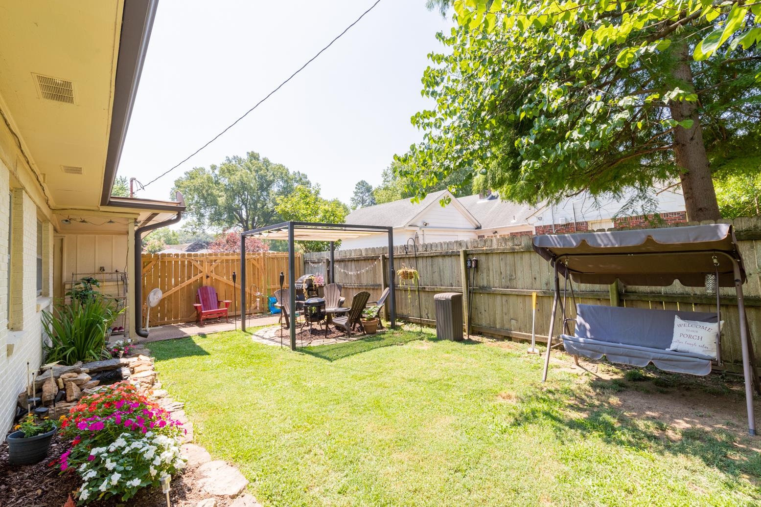 5098 Mason Road Memphis, TN 38117 - Photo 24 of 25 a view of a patio with table and chairs potted plants and large tree
