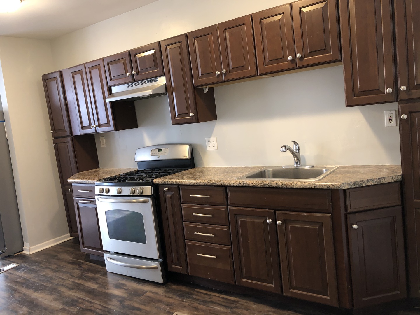 1014 West 19th Street, Unit 1F Chicago, IL 60608 - Photo 11 of 15 a kitchen with stainless steel appliances granite countertop a stove and a microwave
