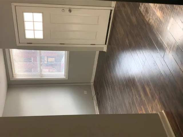 a view of an empty room and a window