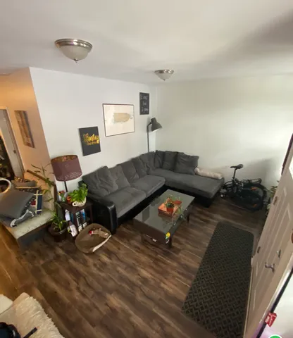 a living room with furniture and a wooden floor