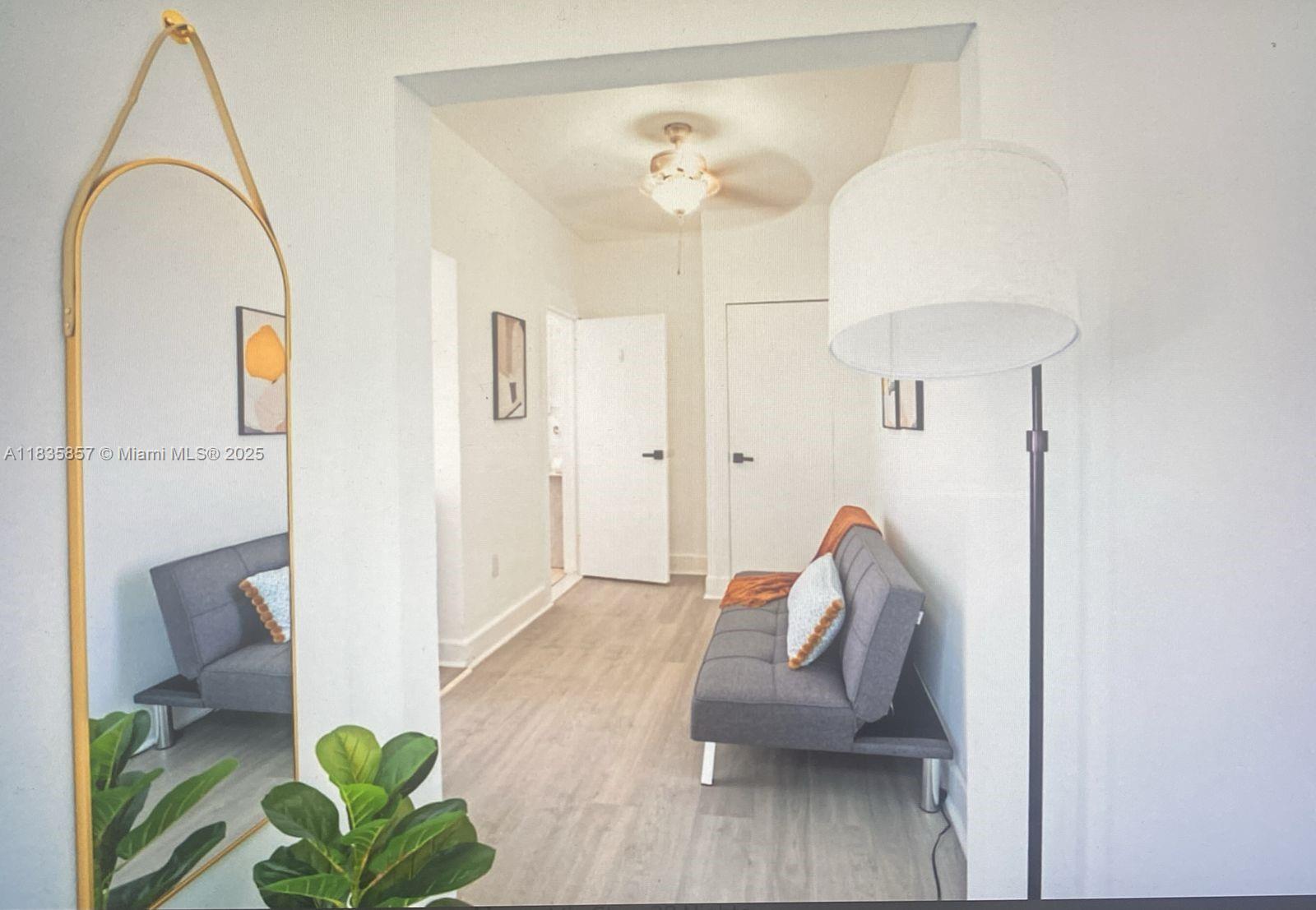 444 Ponce De Leon Boulevard, Unit 12 Coral Gables, FL 33134 - Photo 11 of 14 a living room with furniture and a chandelier