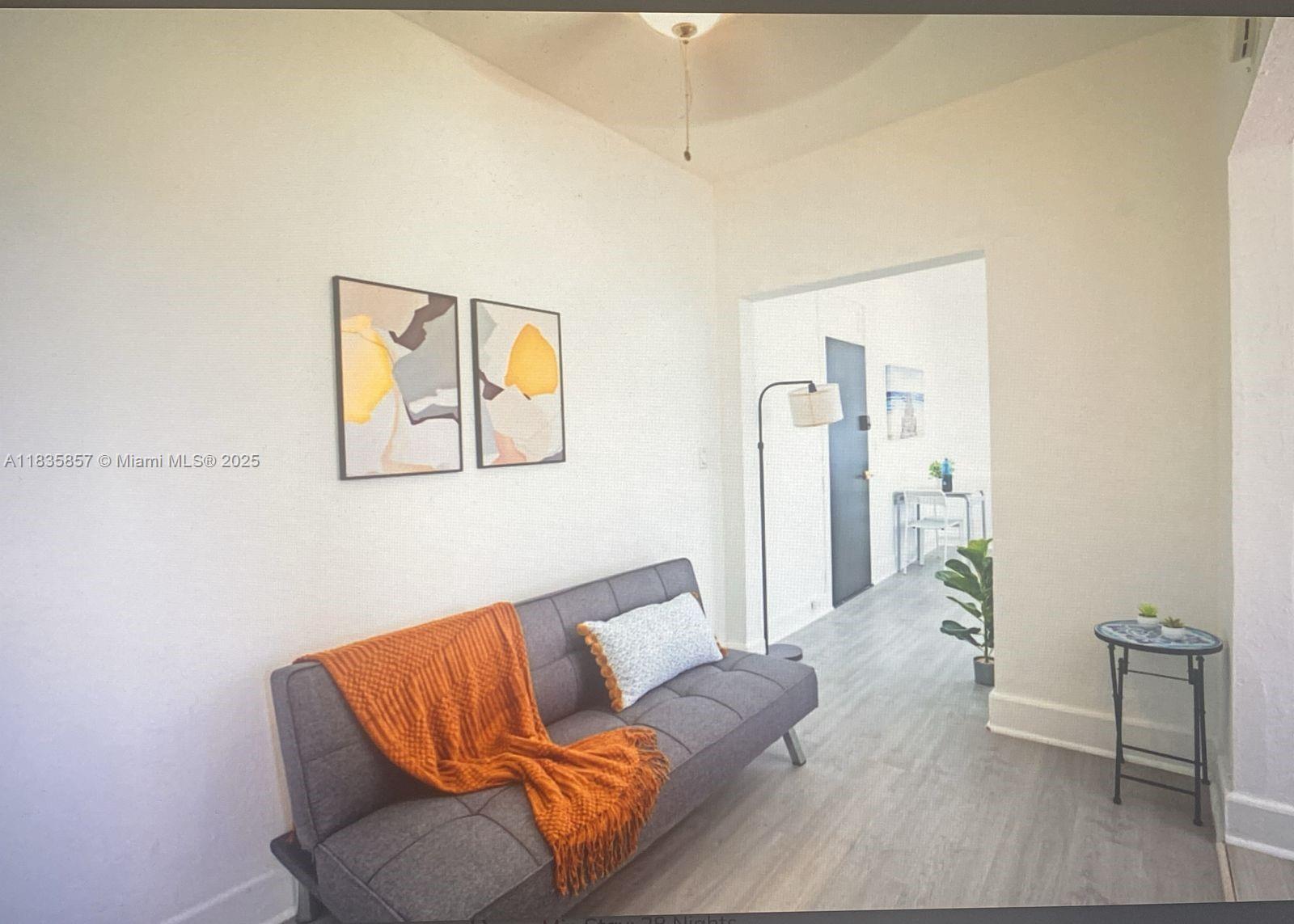 444 Ponce De Leon Boulevard, Unit 12 Coral Gables, FL 33134 - Photo 12 of 14 a living room with furniture and a wooden floor