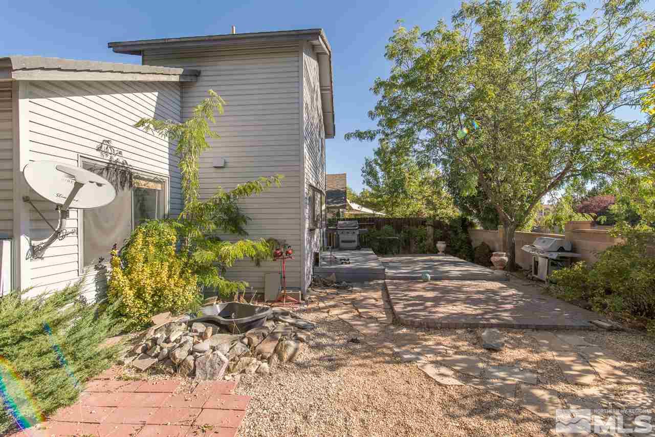 5830 Coyote Ridge Road Reno, NV 89523 - Photo 15 of 16 a backyard of a house with table and chairs