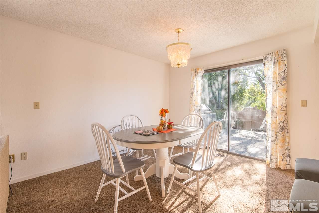 5830 Coyote Ridge Road Reno, NV 89523 - Photo 6 of 16 a view of a dining room with furniture wooden floor and chandelier