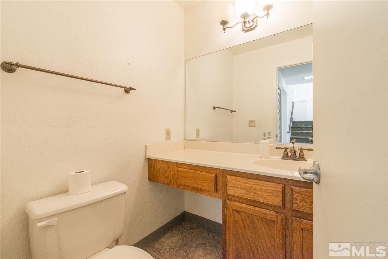 5830 Coyote Ridge Road Reno, NV 89523 - Photo 8 of 16 a bathroom with a sink and mirror with toilet