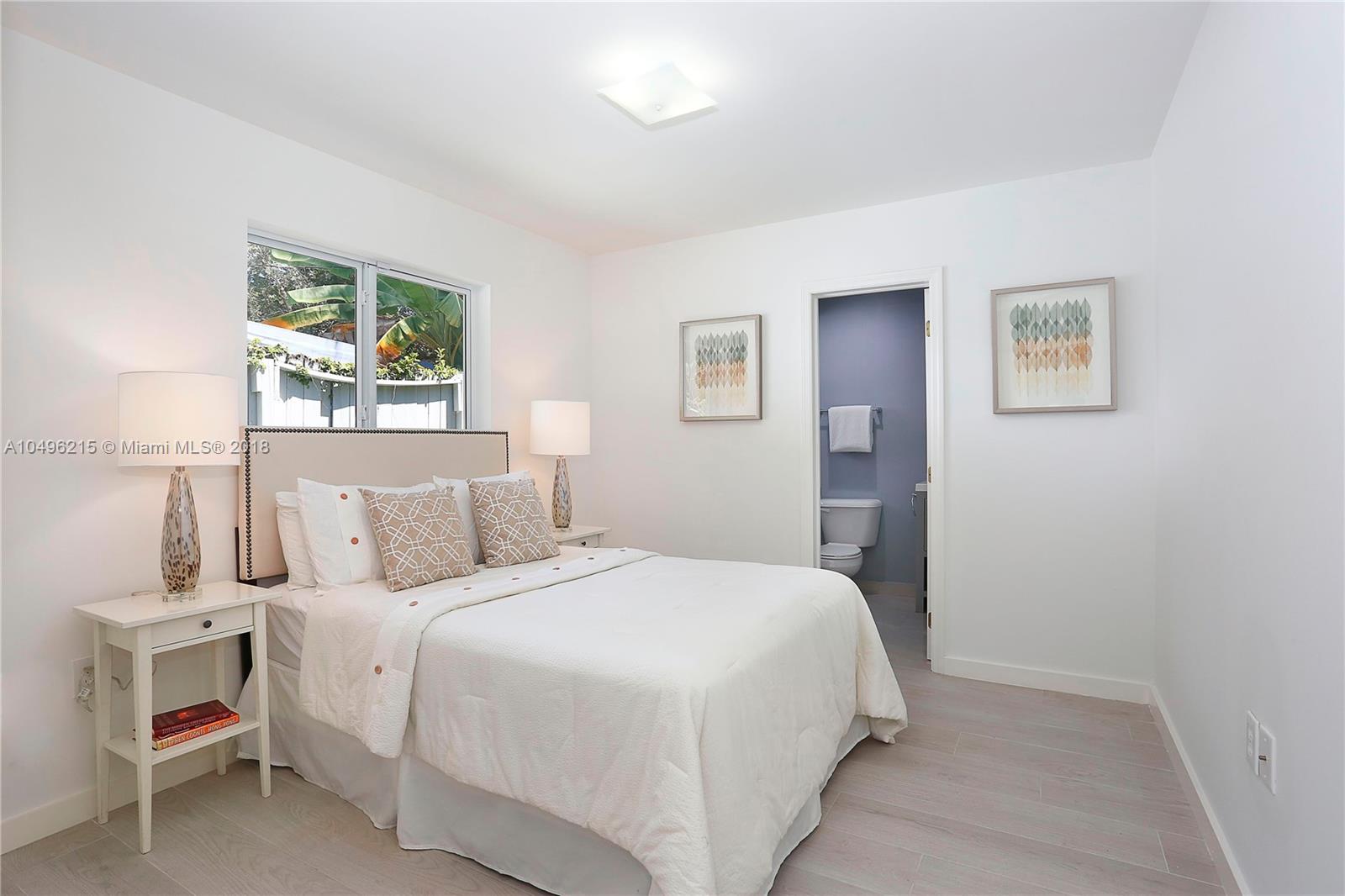 4033 South Le Jeune Road Miami, FL 33146 - Photo 11 of 19 a bedroom with a bed and a painting