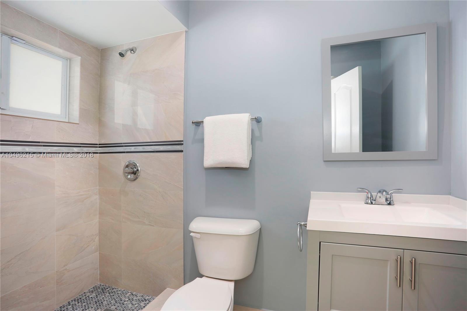4033 South Le Jeune Road Miami, FL 33146 - Photo 12 of 19 a bathroom with a sink a toilet and shower