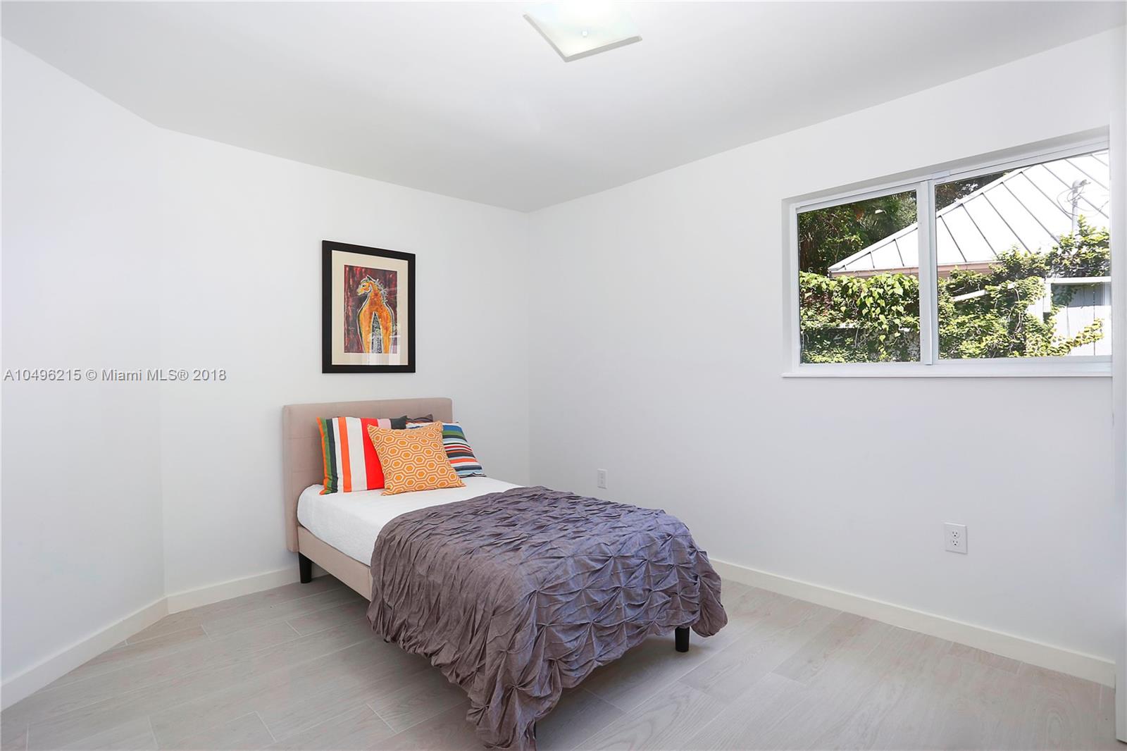 4033 South Le Jeune Road Miami, FL 33146 - Photo 13 of 19 a bedroom with a bed and a painting on the wall