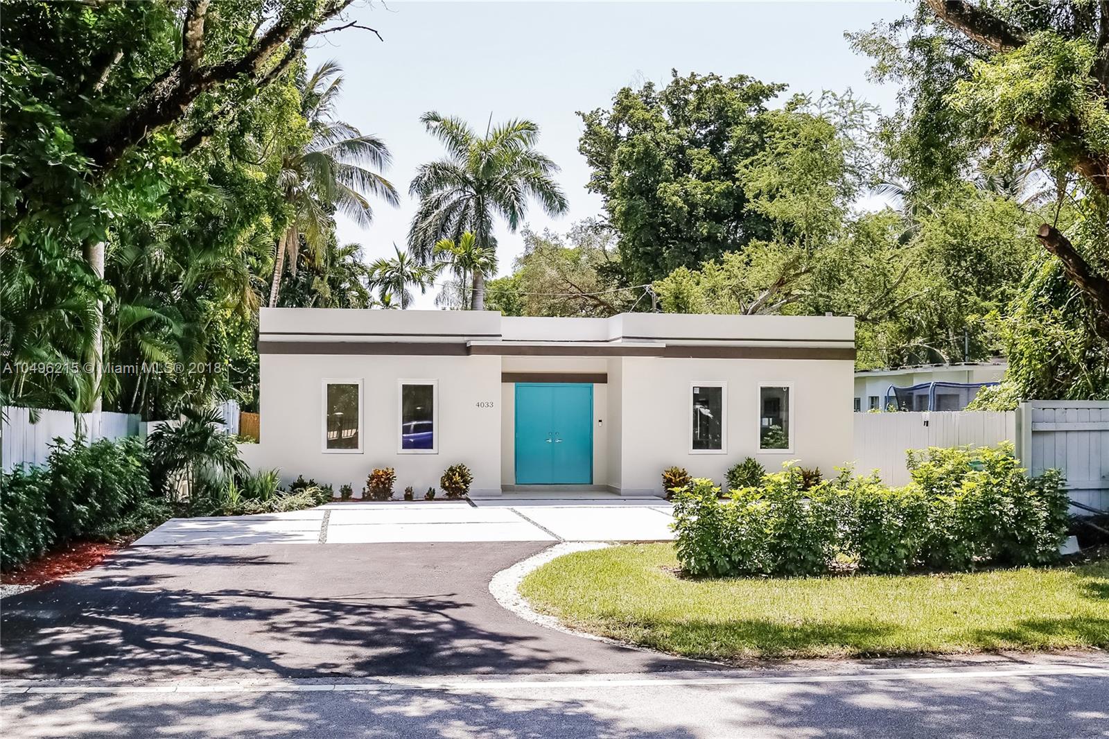 4033 South Le Jeune Road Miami, FL 33146 - Photo 17 of 19 a front view of house with yard and trees around
