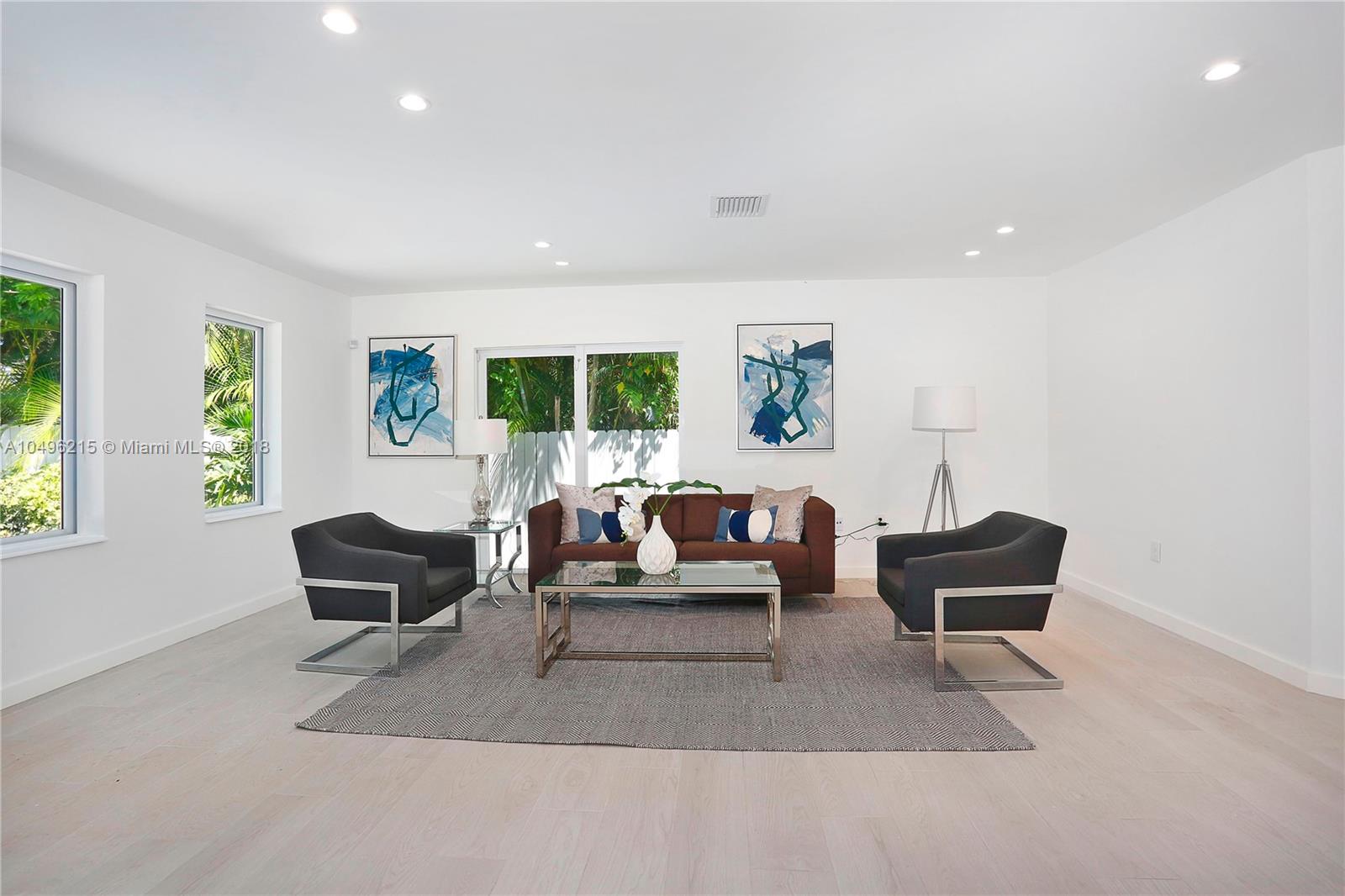 4033 South Le Jeune Road Miami, FL 33146 - Photo 2 of 19 a living room with furniture and a large window