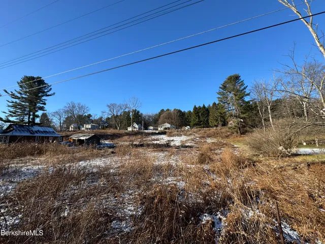 a view of a yard with wooden fence