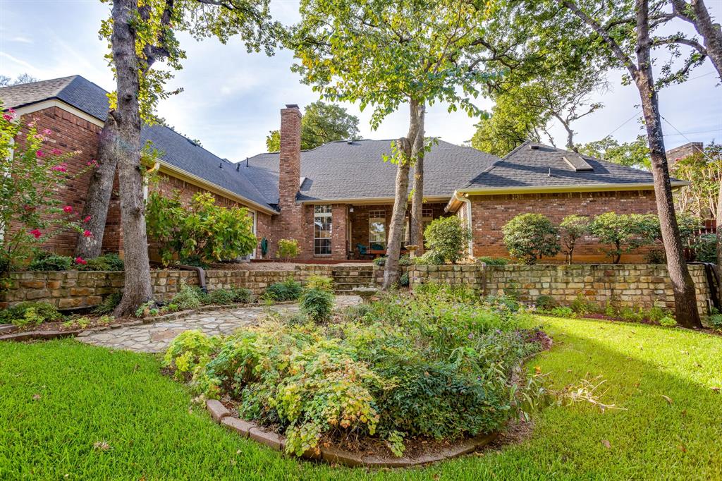3068 High Ridge Drive Grapevine, TX 76051 - Photo 35 of 40 Expansive backyard featuring a manicured lawn, established landscaping, and a flagstone pathway