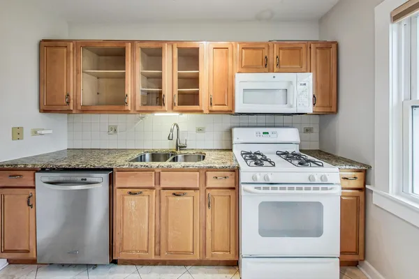 a kitchen with cabinets appliances and a sink