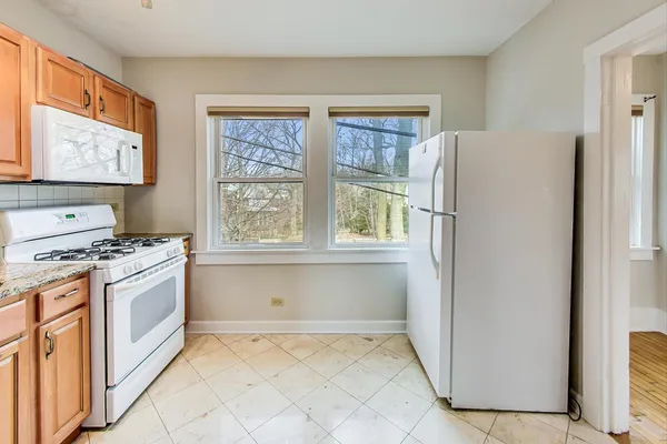 a bathroom with a granite countertop sink toilet and a mirror