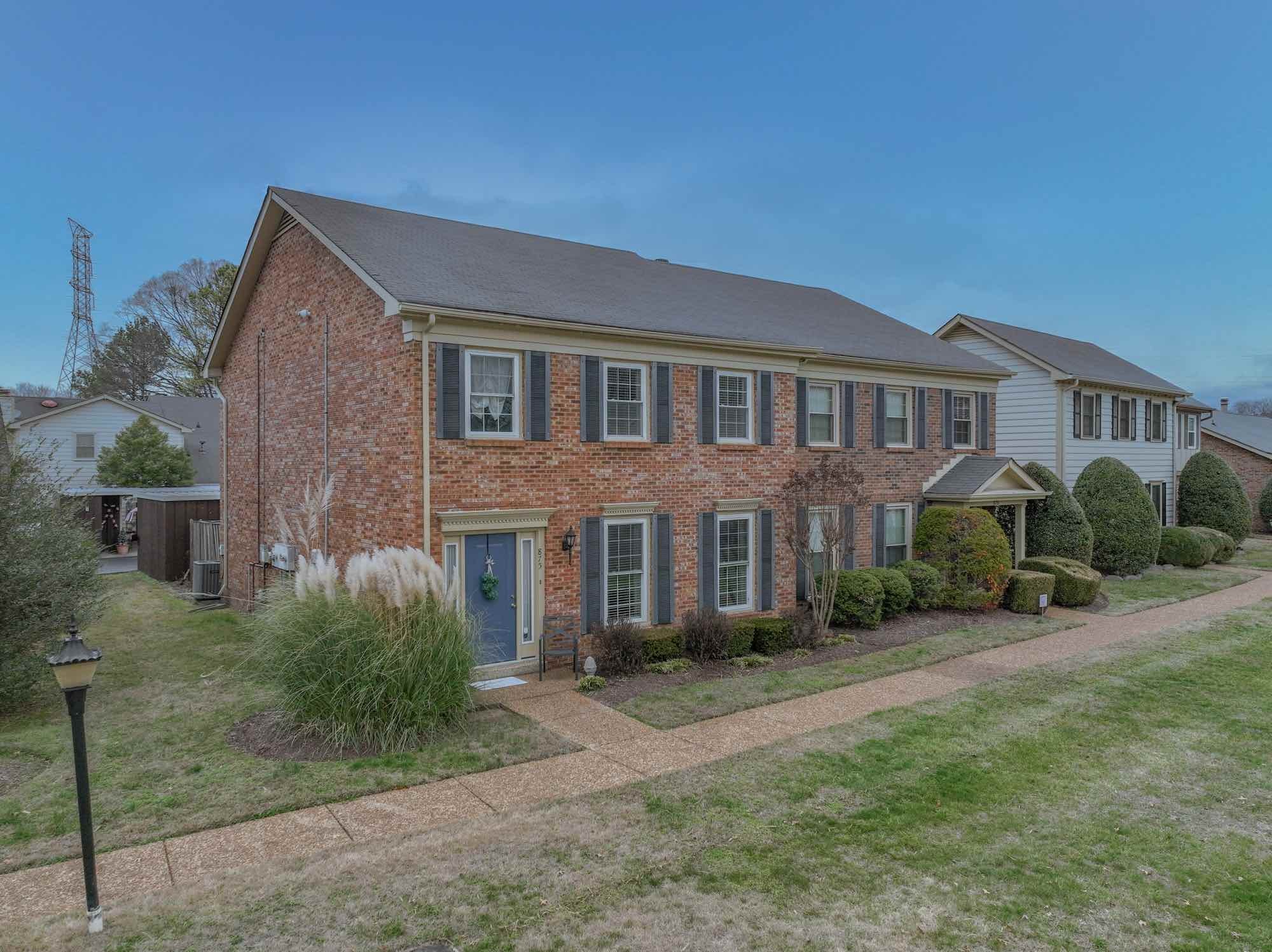 875 General George Patton Road Nashville, TN 37221 - Photo 1 of 42 a front view of a house with garden