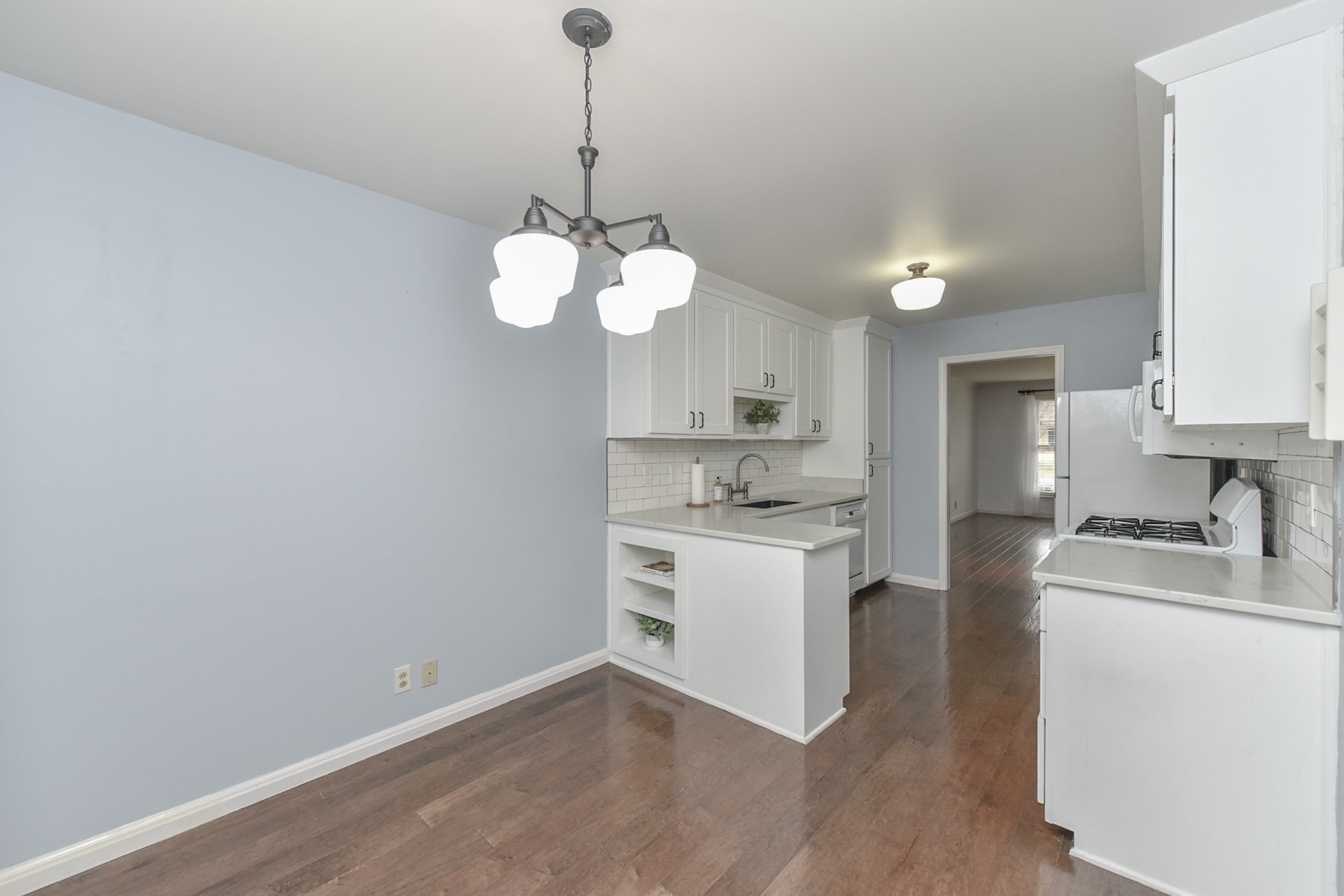 875 General George Patton Road Nashville, TN 37221 - Photo 11 of 42 a kitchen with kitchen island white cabinets stainless steel appliances and kitchen view