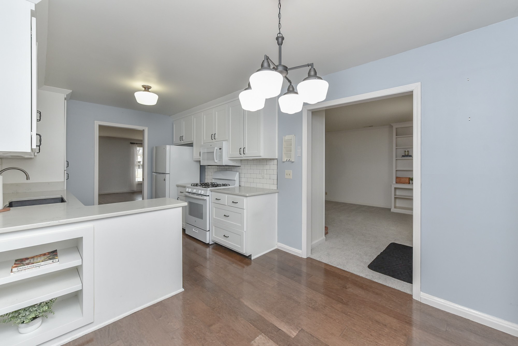 875 General George Patton Road Nashville, TN 37221 - Photo 12 of 42 a view of a kitchen stove a sink and dishwasher with wooden floor