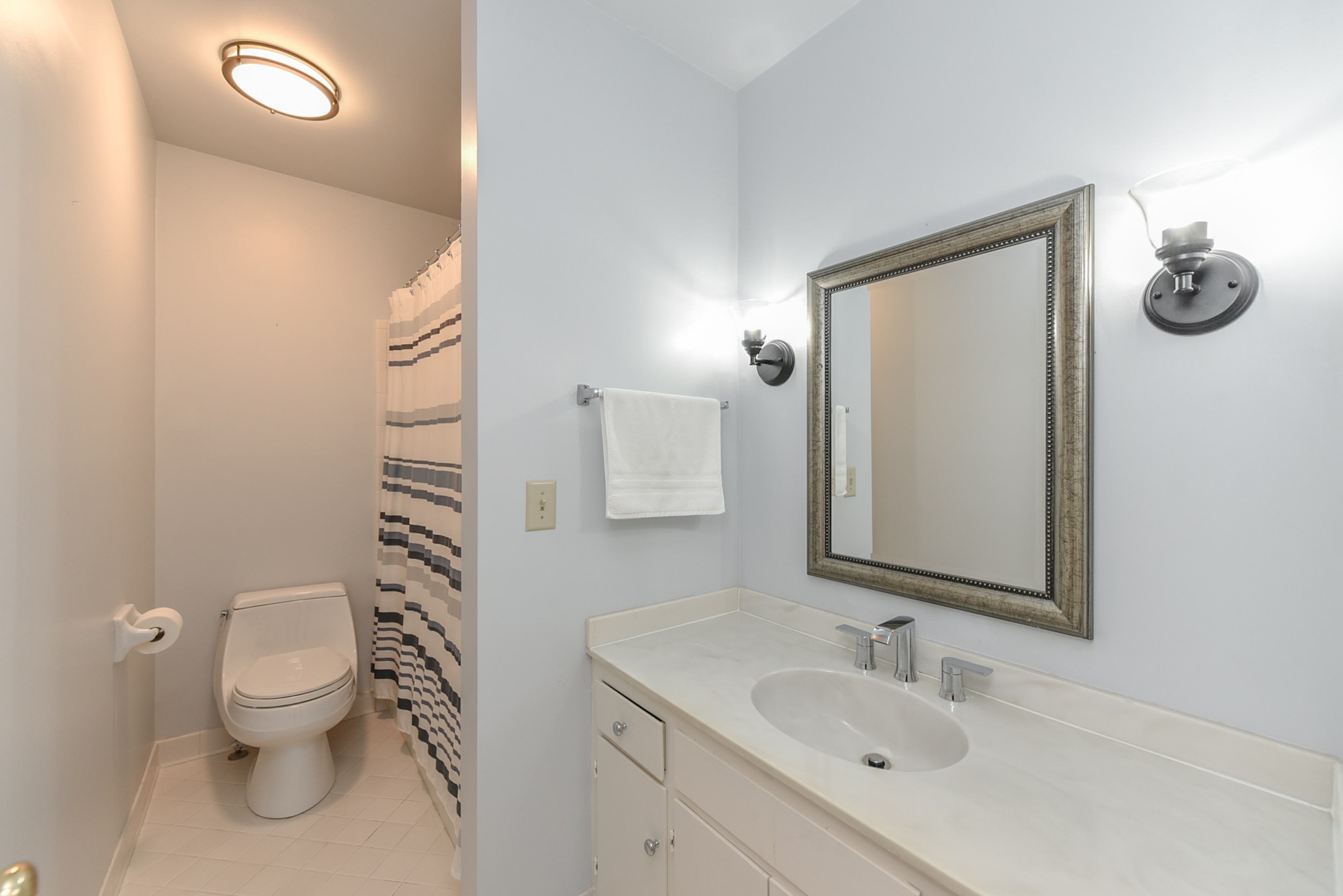875 General George Patton Road Nashville, TN 37221 - Photo 30 of 42 a bathroom with a toilet sink vanity and mirror