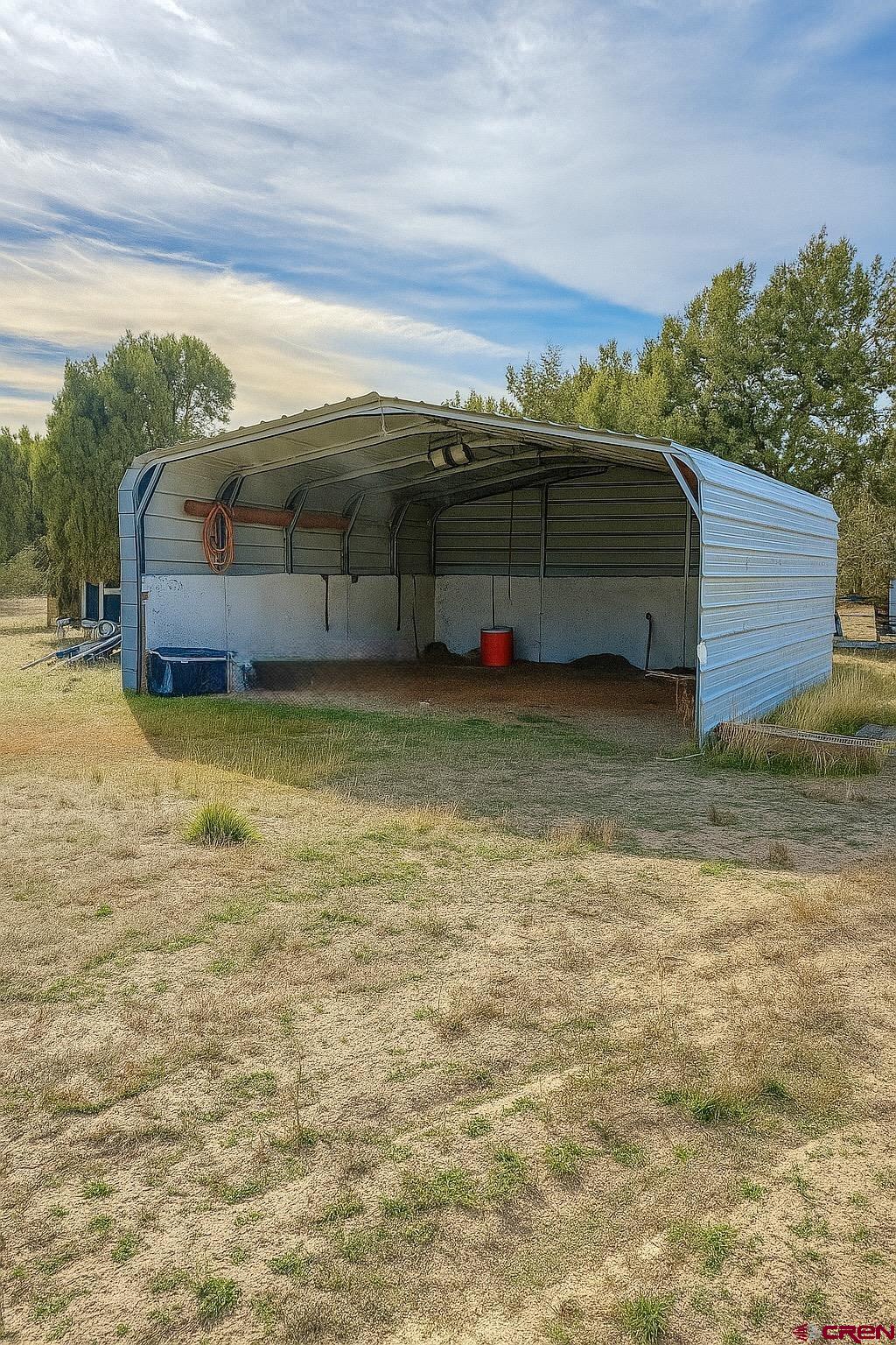 21769 Rd V Lewis, CO 81327 - Photo 5 of 15 a view of a couches in the patio next to a yard