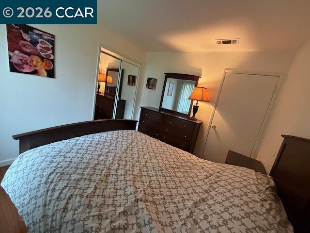 825 Oak Grove Road, Unit 17 Concord, CA 94518 - Photo 13 of 17 a bedroom with a bed and wooden floor
