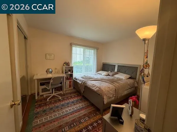 a bedroom with a bed and a table in it