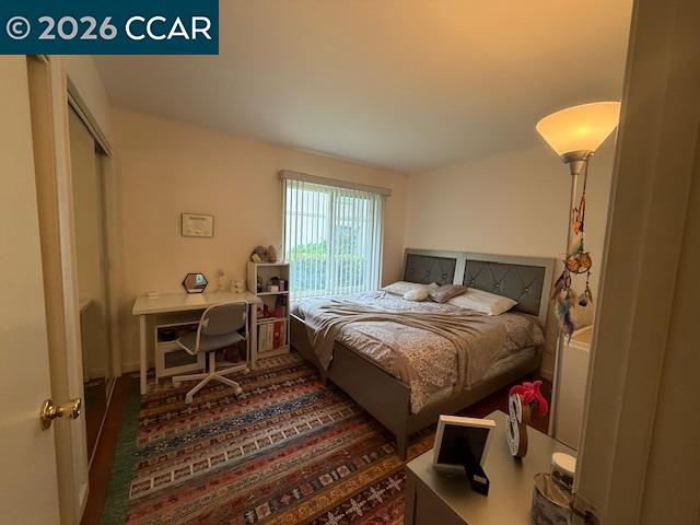 825 Oak Grove Road, Unit 17 Concord, CA 94518 - Photo 14 of 17 a bedroom with a bed and a table in it