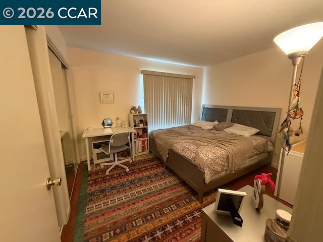 825 Oak Grove Road, Unit 17 Concord, CA 94518 - Photo 15 of 17 a bedroom with a bed and a table in it