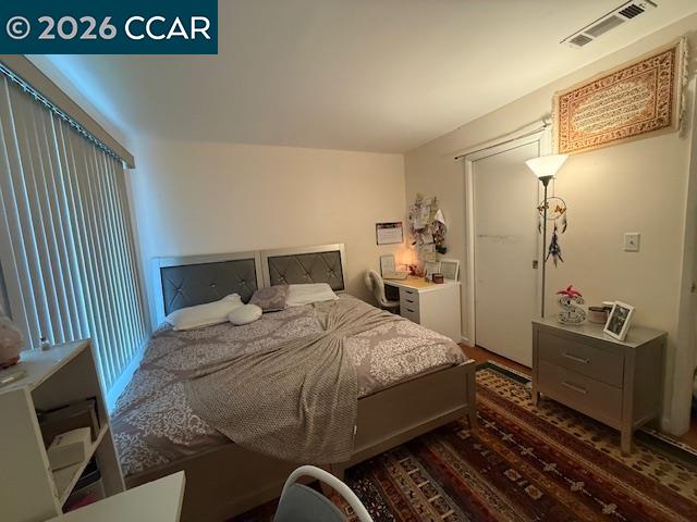825 Oak Grove Road, Unit 17 Concord, CA 94518 - Photo 16 of 17 a bedroom with a bed and wooden floor