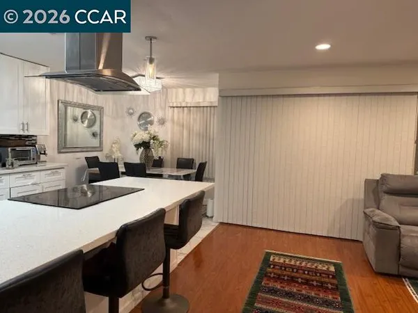 a kitchen with granite countertop a refrigerator and a sink
