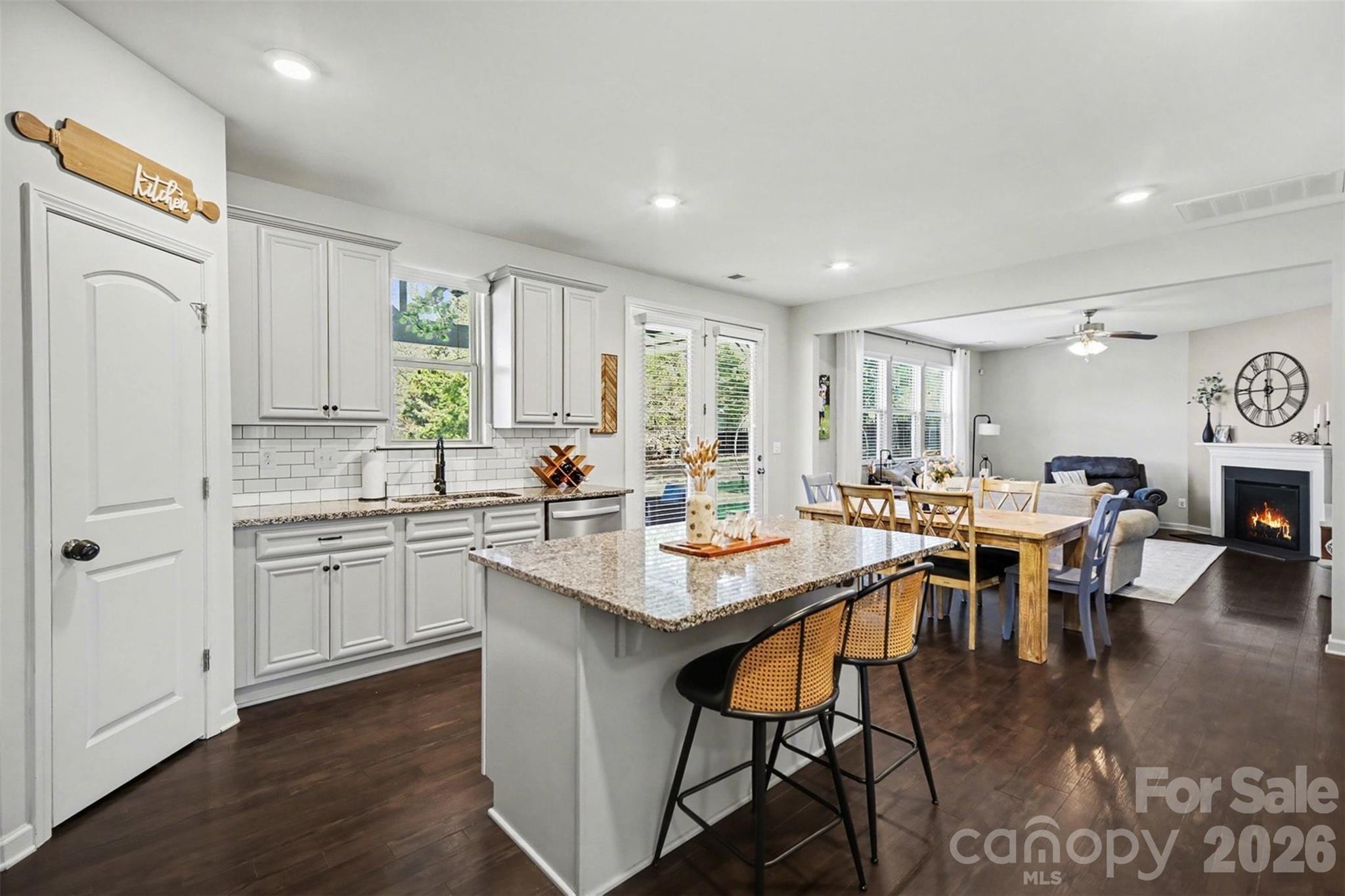 514 Tack Lane Midland, NC 28107 - Photo 9 of 48 a kitchen with stainless steel appliances granite countertop a table chairs sink and white cabinets