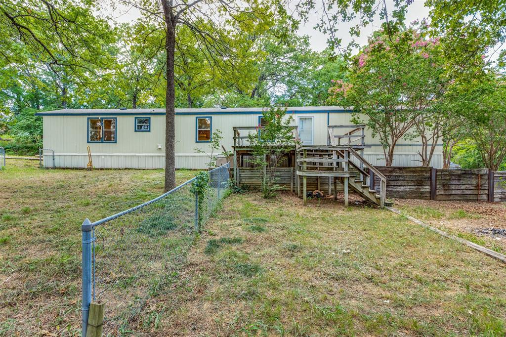28 Wembley Road Gordonville, TX 76245 - Photo 15 of 24 View of the fenced in back yard with 18 ft x 12 ft. deck, great for entertaining.