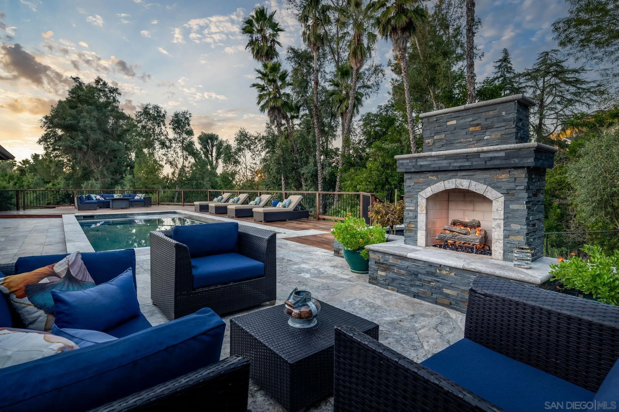 a outdoor living space with furniture and a fireplace