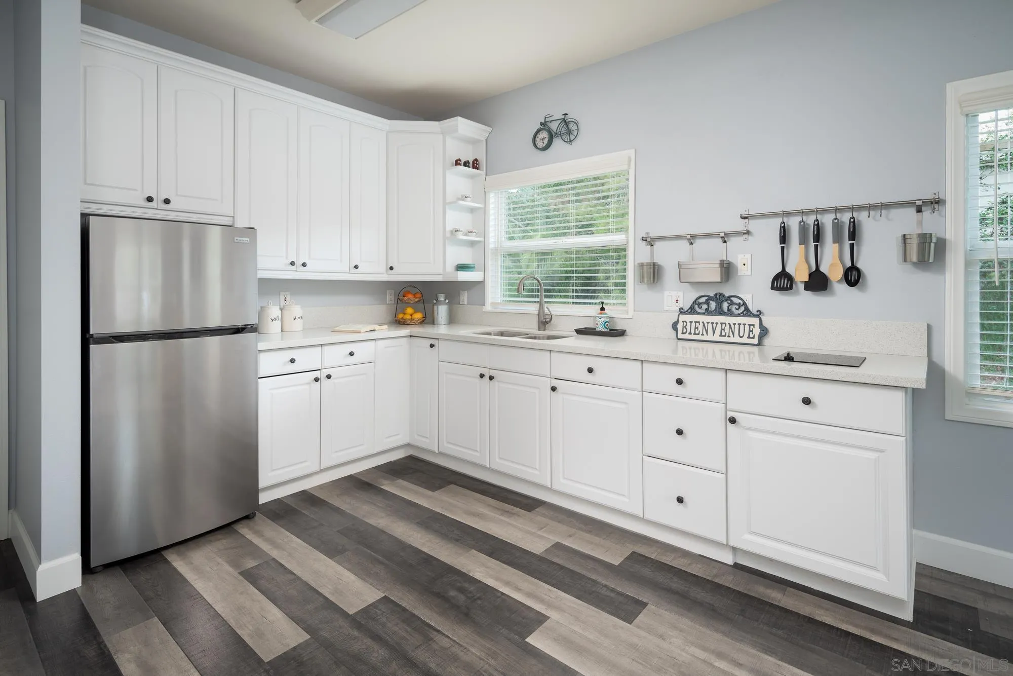 13384 Fallen Leaf Road Poway, CA 92064 - Photo 21 of 27 a kitchen with white cabinets and white appliances
